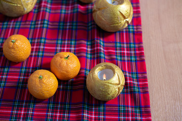 Christmas composition with tangerines and a cup of tea. New Year home room decoration.