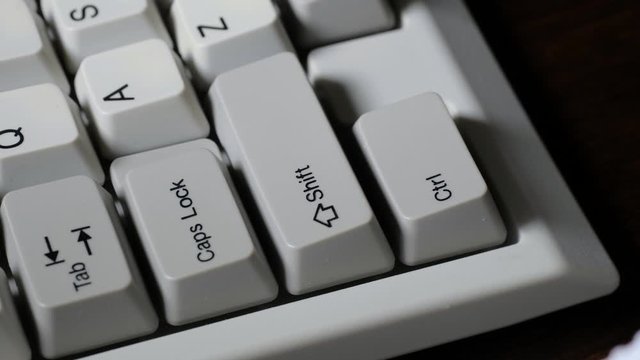 Finger presses LEFT CTRL button on keyboard