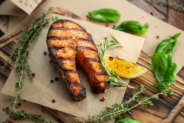 grilled salmon steak with vegetables on plate