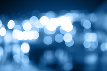 Dark classic blue bokeh background. Defocus image with blue lights in bokeh