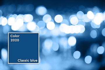 Dark classic blue bokeh background. Defocus image with blue lights in bokeh