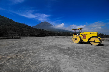 Beautiful view of Road Roller on a land leveling project in the mountain background