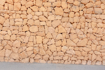 Masonry wall of stones with irregular pattern texture background