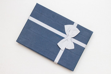 classic blue gift box with ribbon and bow on white background