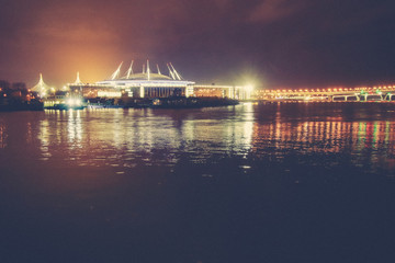 Massive building skyline light with reflection in the water. Night exposure landscape.