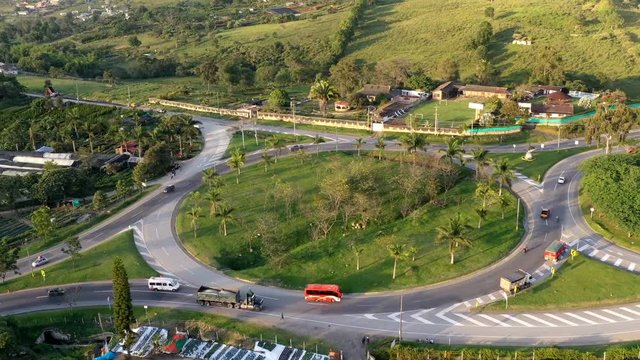 Time lapse aerial video of a roundpoint of colombian national route, you can see how the cars pass for the roundpoint until you look the sunset