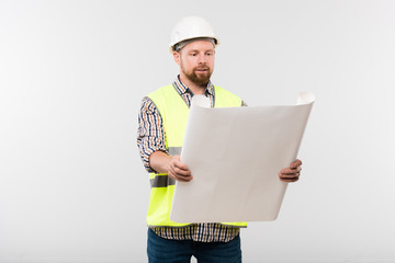 Successful engineer or foreman in helmet and workwear holding blueprint