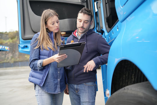 Logistics manager controlling truck driver schedule