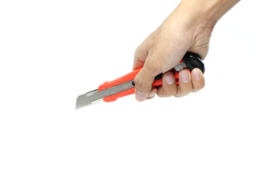 Hand holding a red cutter knife. The blade is open, isolated on white background.