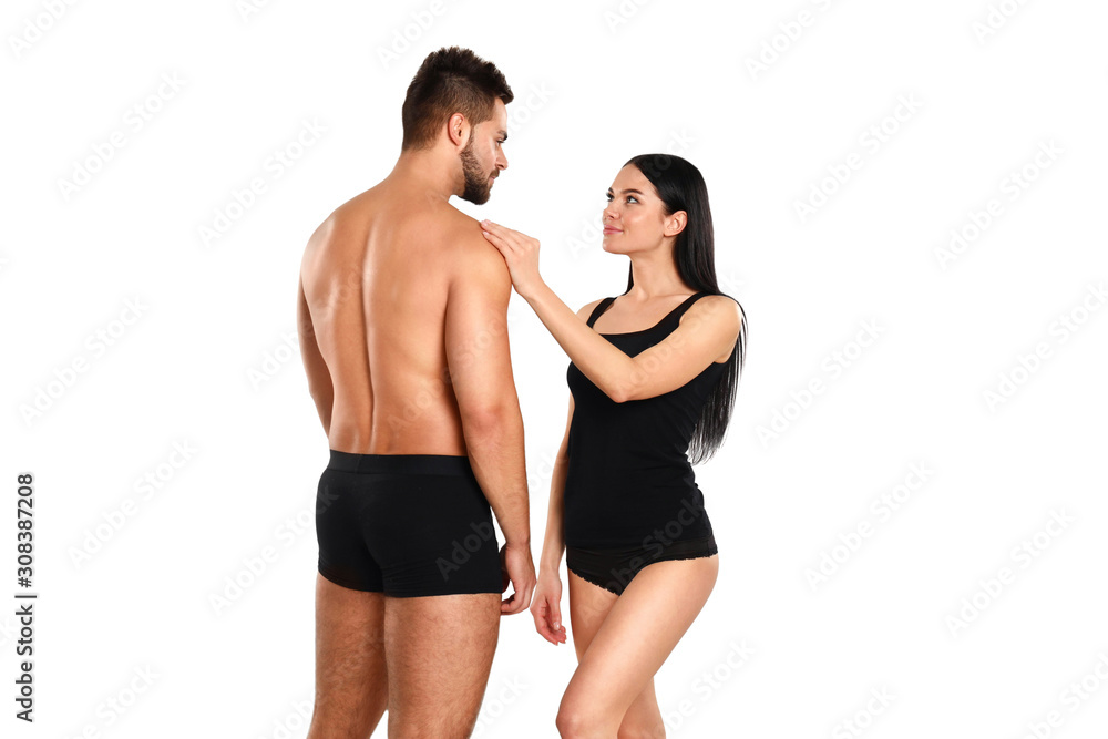 Wall mural young couple in black underwear on white background