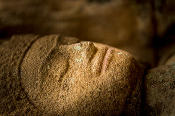 replying buddah, closeup with blurred background of a stone statue 