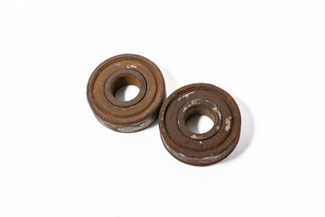 Rusty stuck ball bearings on a white background isolated
