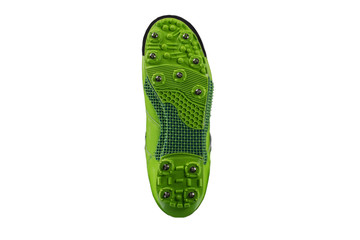 Green sole with spiked sneakers on a white background. Sport shoes.