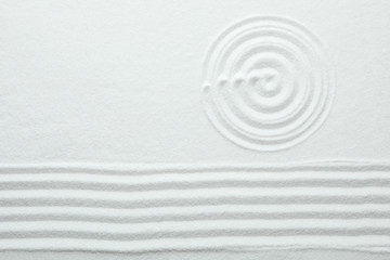 Fototapeta na wymiar Top view of white sand with pattern. Zen and harmony