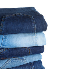 Stack of different jeans isolated on white