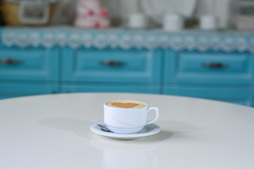 Delicious cappuccino on a large bright table in a cozy coffee shop