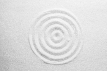 Fototapeta na wymiar White sand with pattern as background, top view. Zen, meditation, harmony