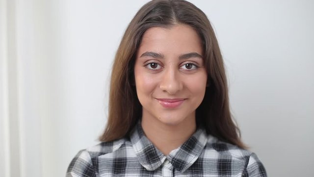 Portrait of a happy indian asian woman on white background. Closeup of a beautiful arab girl.