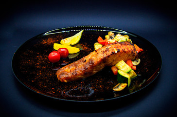Salmon under teriyaki sauce on black background