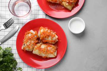 Delicious cabbage rolls served on grey table, flat lay