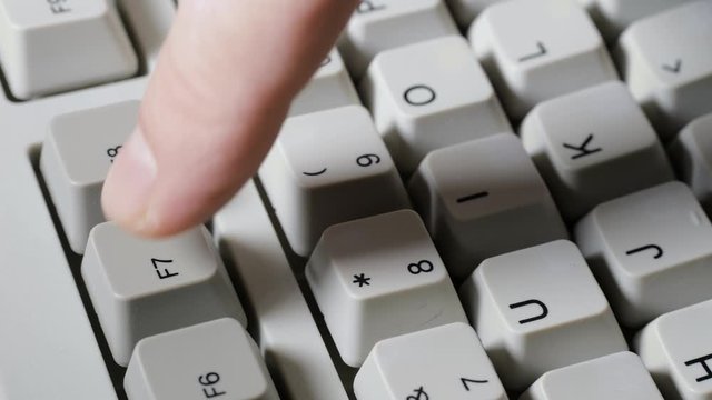 Finger presses F7 button on keyboard