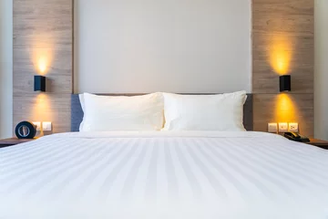Foto op Aluminium White comfortable pillow on bed decoration interior © siraphol