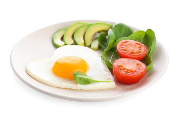 Plate of tasty breakfast with heart shaped fried egg isolated on white