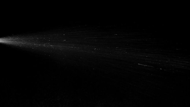 white vapour or spray water on a black background ,slow motion movement