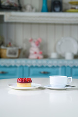 Delicious berry tea and tarte with raspberries on a table in a cozy coffee shop