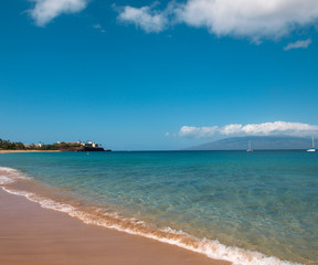 Pacific ocean shoreline as seen from the beach in Hawaii