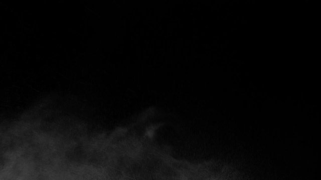 white vapour or spray water on a black background ,slow motion movement