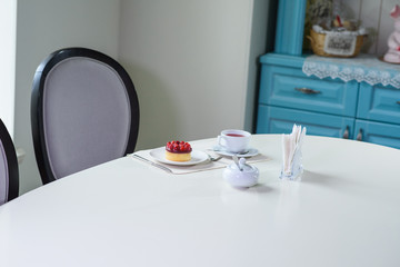 Delicious berry tea and tarte with raspberries prepared on a table for a guest in a cozy cafe