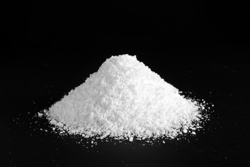 Heap of white snow on black background