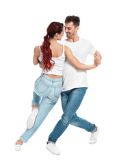 Beautiful young couple dancing on white background