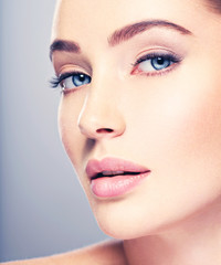 Fototapeta premium Beautiful face of young woman with perfect skin