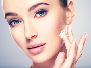 Fototapeta premium woman gets cream in the face. Skin care concept.
