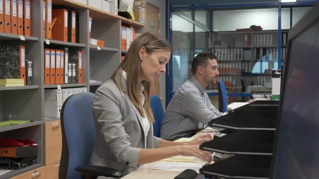 Office manager giving instructions to workmate