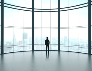 Fototapeta na wymiar Businessman standing in contemporary office