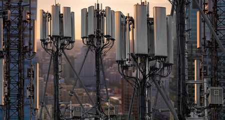 base stations and mobile phone transmitters against the backdrop of a modern city