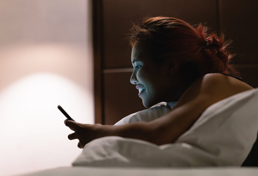 Young diverse Asian business woman using the internet on smartphone device - Millennial social influencer girl playing on mobile phone e-commerce shopping - Lifestyle, tech and digital concept