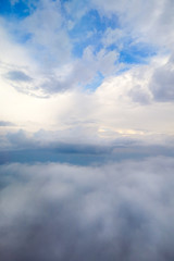 Naklejka na ściany i meble White clouds and sky view from the airplane window.