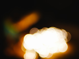 lights from garlands in defocus. Christmas background. Festive abstract background with bokeh defocused lights and stars