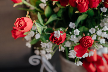A bouquet of red roses beside the sofa