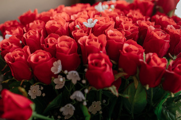A bouquet of red roses beside the sofa