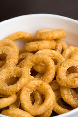 Fried onion snacks in white bowl. 