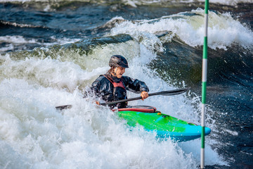 Whitewater kayaking, extreme sport rafting. Guy in kayak sails mountain river