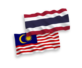 National vector fabric wave flags of Thailand and Malaysia isolated on white background. 1 to 2 proportion.