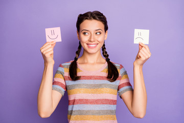 Photo of funny lady holding paper emoticons good and bad mood picking positive emotions wear casual...