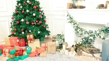 Christmas tree decorated holiday winter xmas celebration present gift to family decorate with ornament golden ball in cozy living room. Merry Christmas and happy new year festival traditional concept.