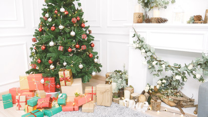 Christmas tree decorated holiday winter xmas celebration present gift to family decorate with ornament golden ball in cozy living room. Merry Christmas and happy new year festival traditional concept.